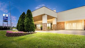 A modern building with a landscaped front yard, a Best Western sign, and a brick facade.