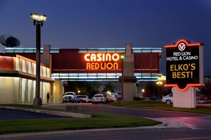 A building with a large illuminated sign reading "CASINO REDLION" and a smaller sign stating "RED LION HOTEL & CASINO ELKO'S BEST!"