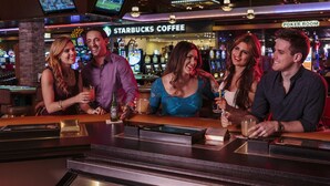 A bar area with a Starbucks Coffee sign and a Poker Room sign. - Maverick Hotel and Casino by Red Lion Hotels (Elko)