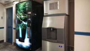 A vending machine with a nature-themed display and a water dispenser. - Motel 6 Fort Worth, TX - Downtown East (Fort Worth)