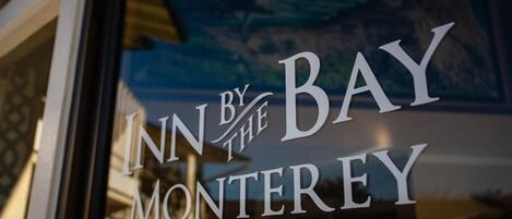 A hotel sign with the text 'INN BY THE BAY MONTEREY'.