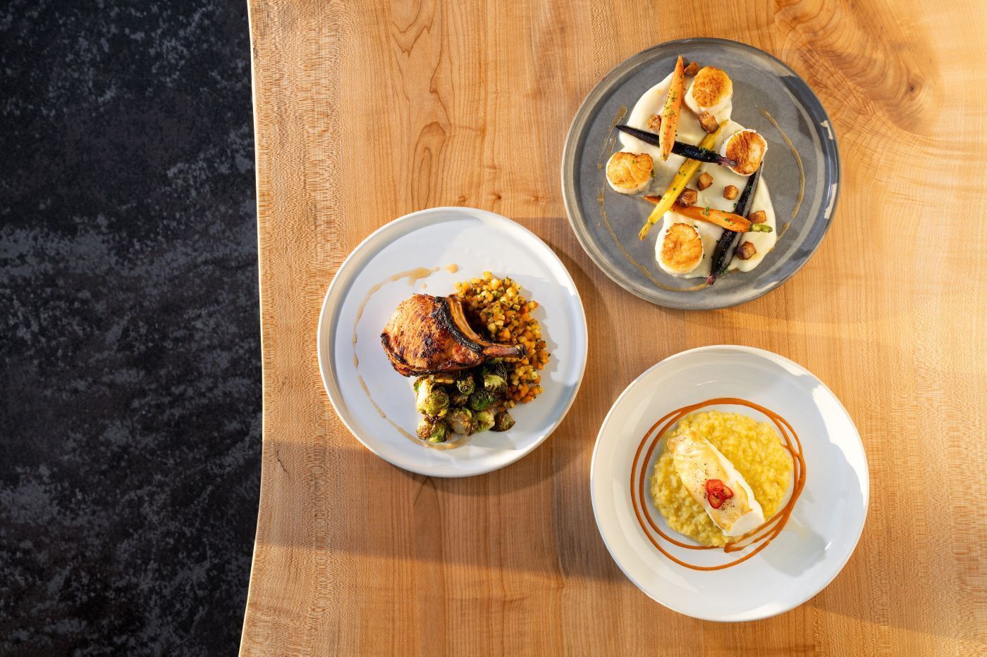 Three dishes on a wooden table.