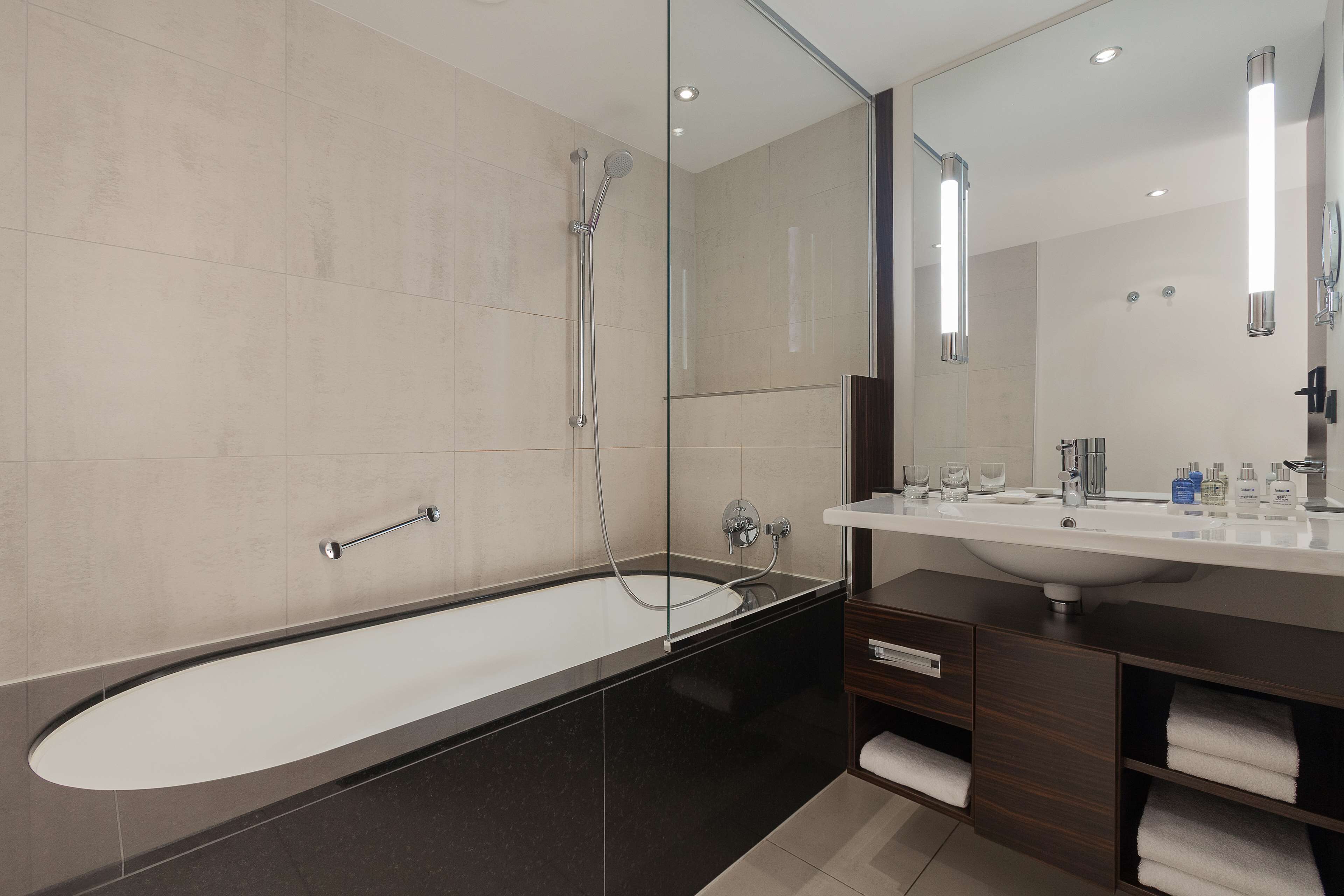 rainfall showerhead, eco-friendly toiletries, hair dryer, towels