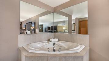 Suite, 1 King Bed, Non Smoking, Jetted Tub | Desk, laptop workspace, blackout drapes, iron/ironing board