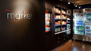 A modern interior with a dark wall and a sign reading "the market".
