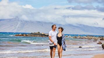 On the beach, white sand, sun loungers, beach umbrellas