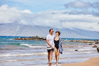 On the beach, white sand, sun loungers, beach umbrellas at Andaz Maui at Wailea Resort - a concept by Hyatt