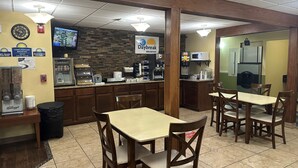 A breakfast area with a Daybreak sign, a coffee machine, and a microwave. - Days Inn & Suites by Wyndham Gunnison (Gunnison)