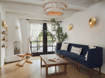 A spacious lobby with a large chandelier, a fireplace, and a patterned floor. at The Scott Resort & Spa