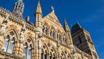 A historic building with intricate Gothic architecture, including pointed arches and detailed stonework.
