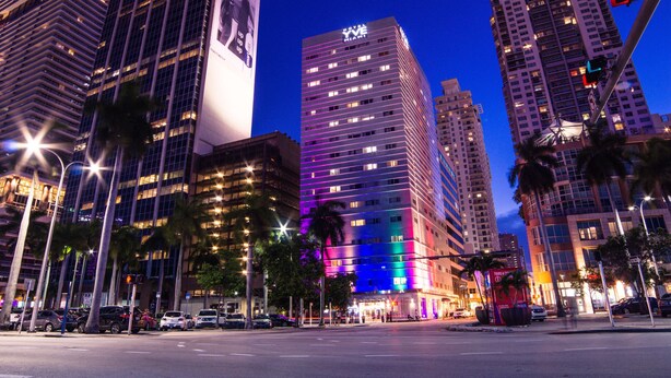 A high-rise hotel with a prominent 'Yve' sign, surrounded by other tall buildings and palm trees. - YVE Hotel Miami (Miami)