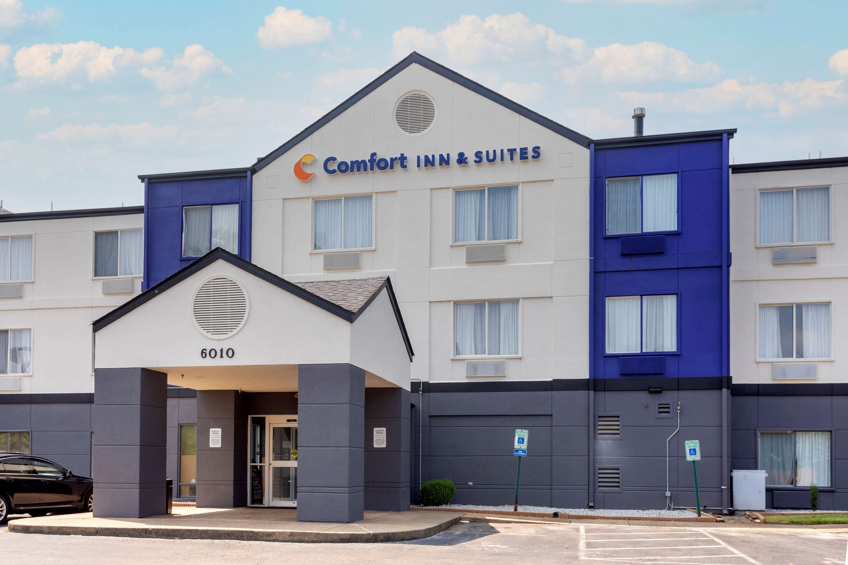 A hotel with a sign reading "Comfort Inn & Suites" and the number "6010" on the entrance.