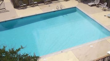 Seasonal outdoor pool, open 10:00 AM to 10:00 PM, pool umbrellas