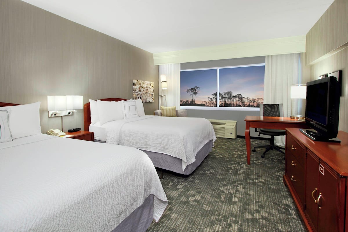 Premium bedding, desk, laptop workspace, blackout drapes