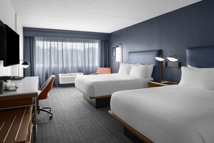 Premium bedding, desk, laptop workspace, blackout drapes