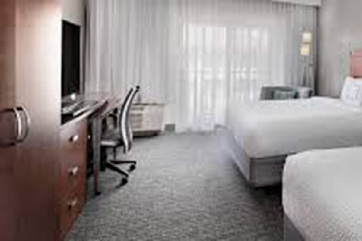Premium bedding, desk, laptop workspace, blackout drapes