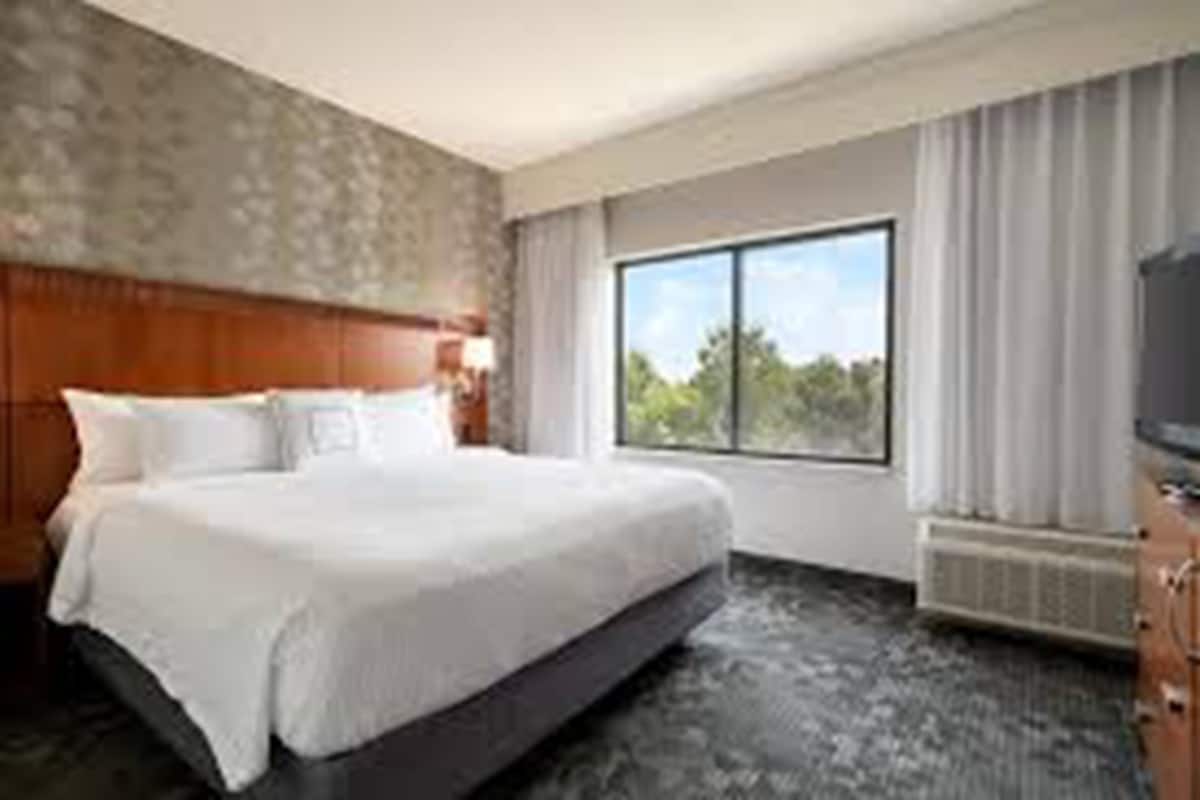 Premium bedding, desk, laptop workspace, blackout drapes