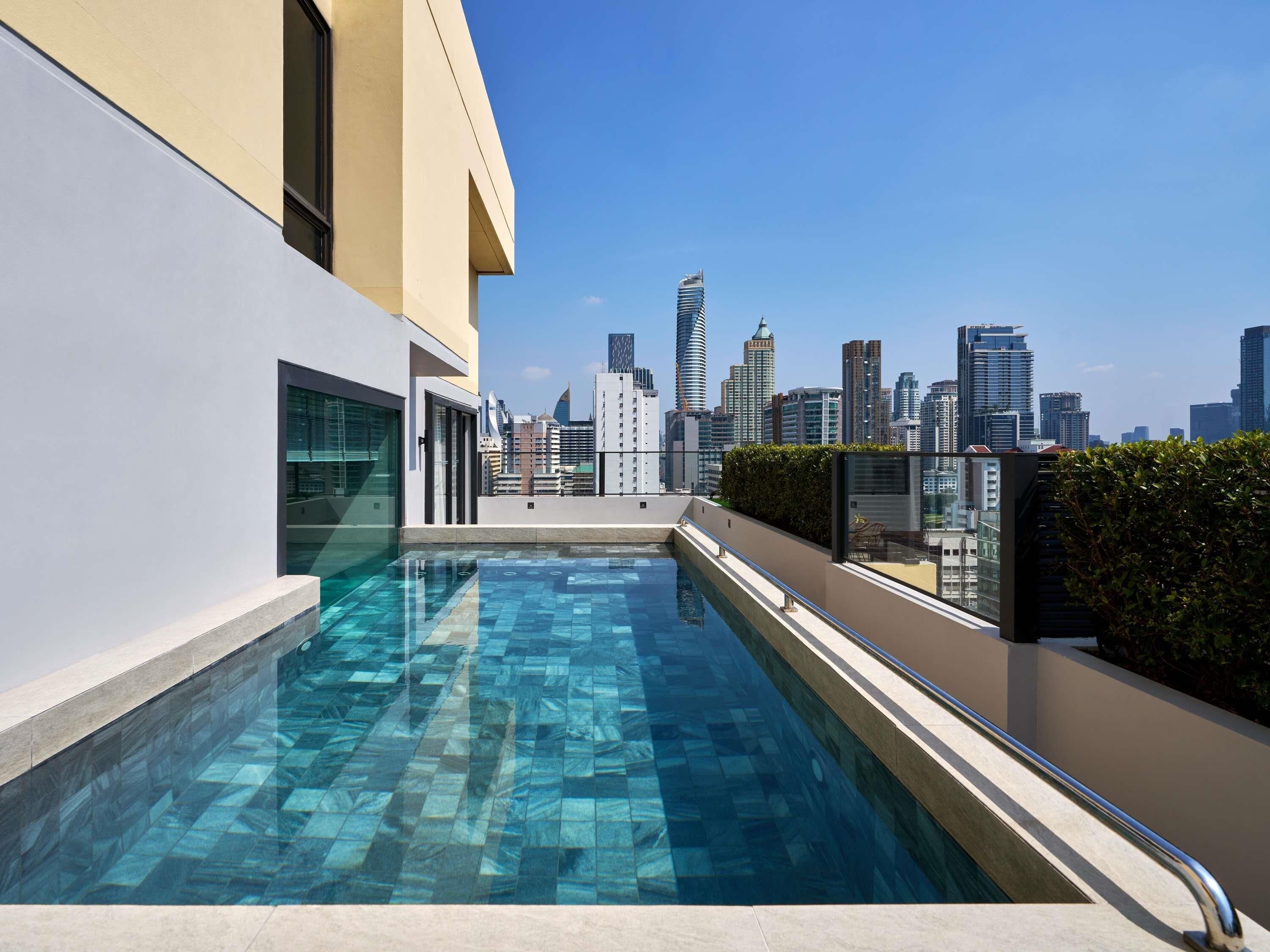 A rooftop pool with a city skyline view.