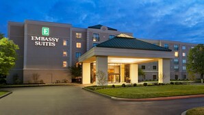 A modern building with a sign reading "Embassy Suites."