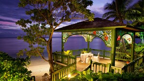A gazebo with a view of the sea, surrounded by tropical plants and a wooden deck. - Shangri-La Yanuca Island, Fiji (Yanuca Island)