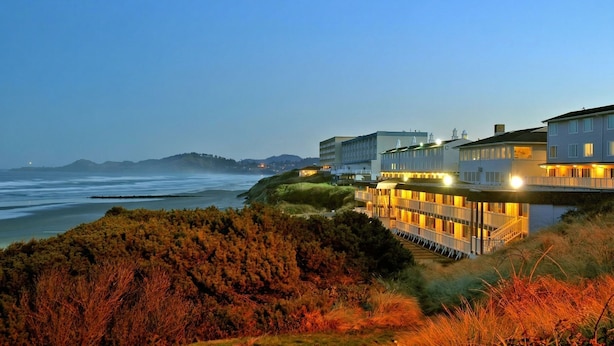 A coastal hotel with multiple buildings, a waterfront view, and a staircase leading to the upper levels. - Seagrass Oceanfront Inn (Newport)