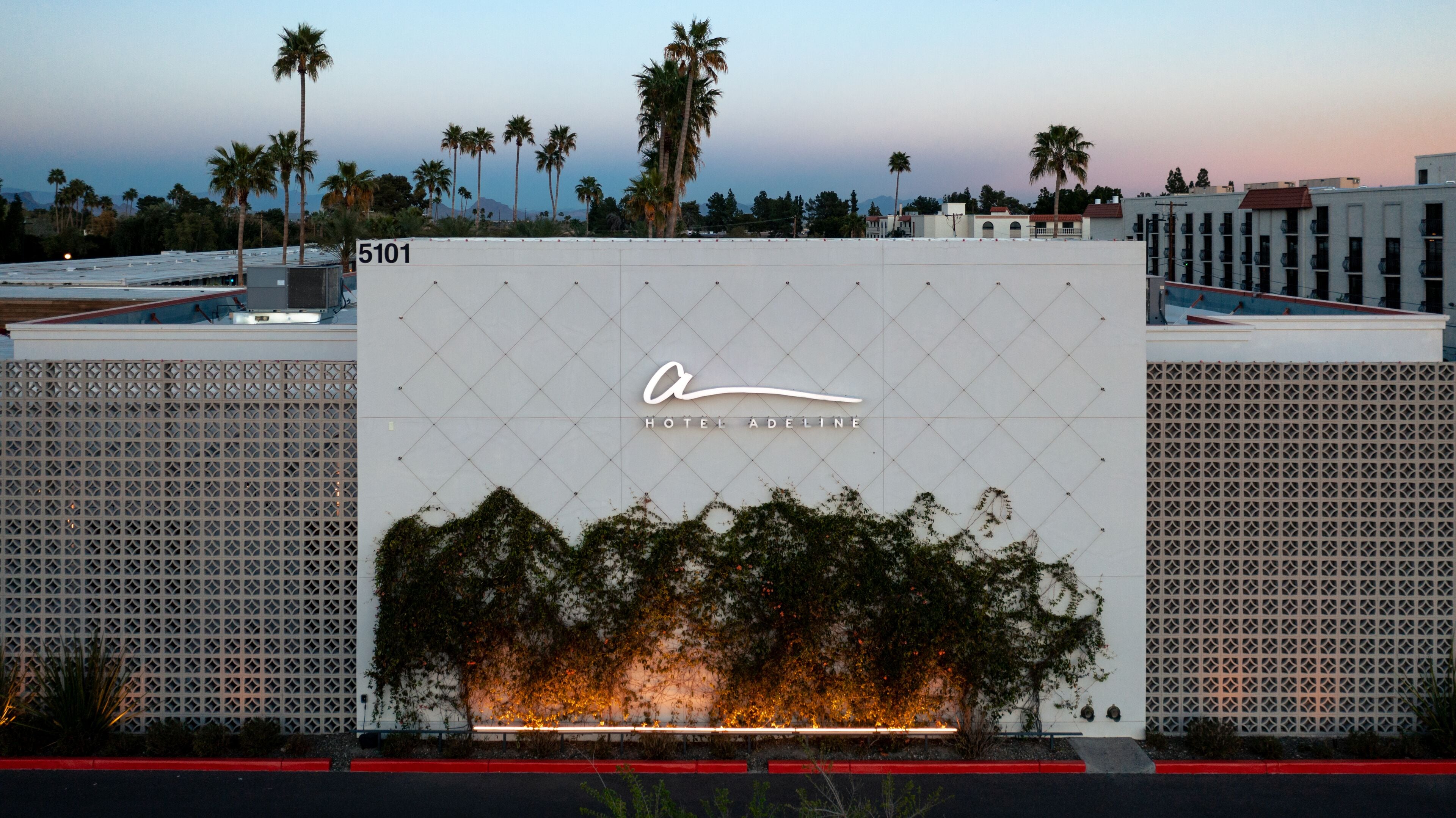 A building with a large sign reading "Hotel Adeline" and a number "5101" on the left.