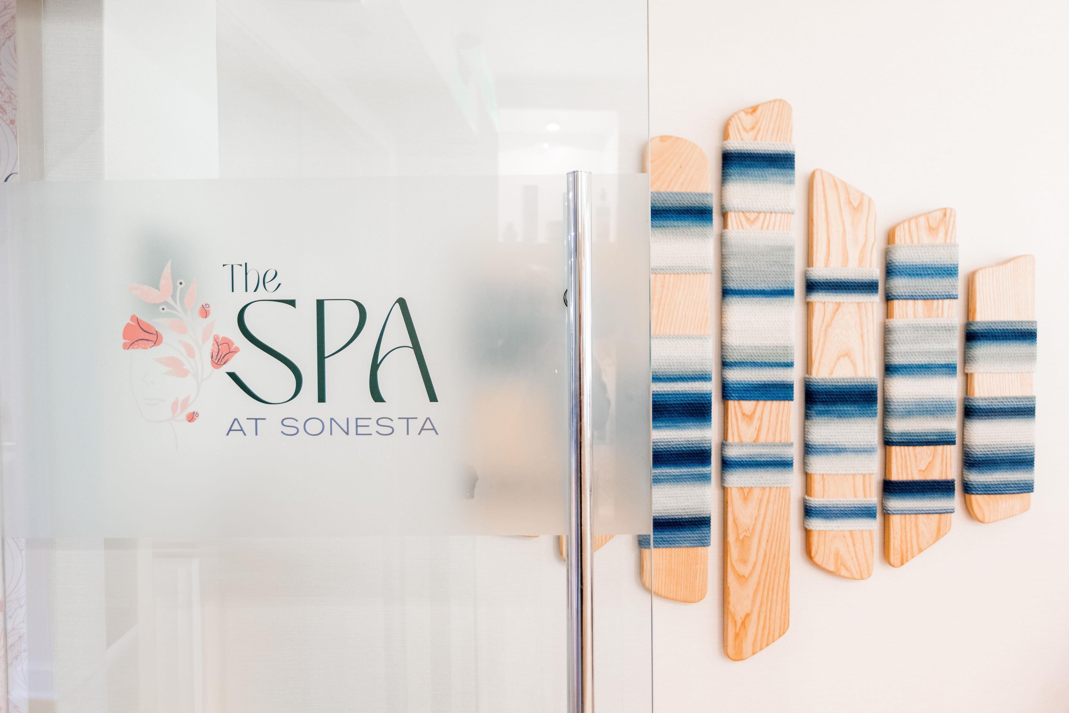 Un réfrigérateur décoré d’un autocollant sur le thème d’un spa et doté de planches à découper en bois.