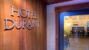 A wooden sign with "HOTEL DURANT" lettering. - Hotel Durant (Aspen)