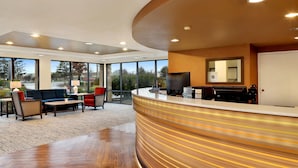 A reception area with a curved counter, seating, and large windows. - Comfort Inn Bellingham (Bellingham)