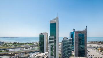 A cityscape with modern high-rise buildings, a bridge, and a body of water.