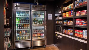 A vending area with multiple beverage dispensers and snack shelves.