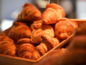 A wooden tray filled with croissants. - ibis Chateauroux (Chateauroux)