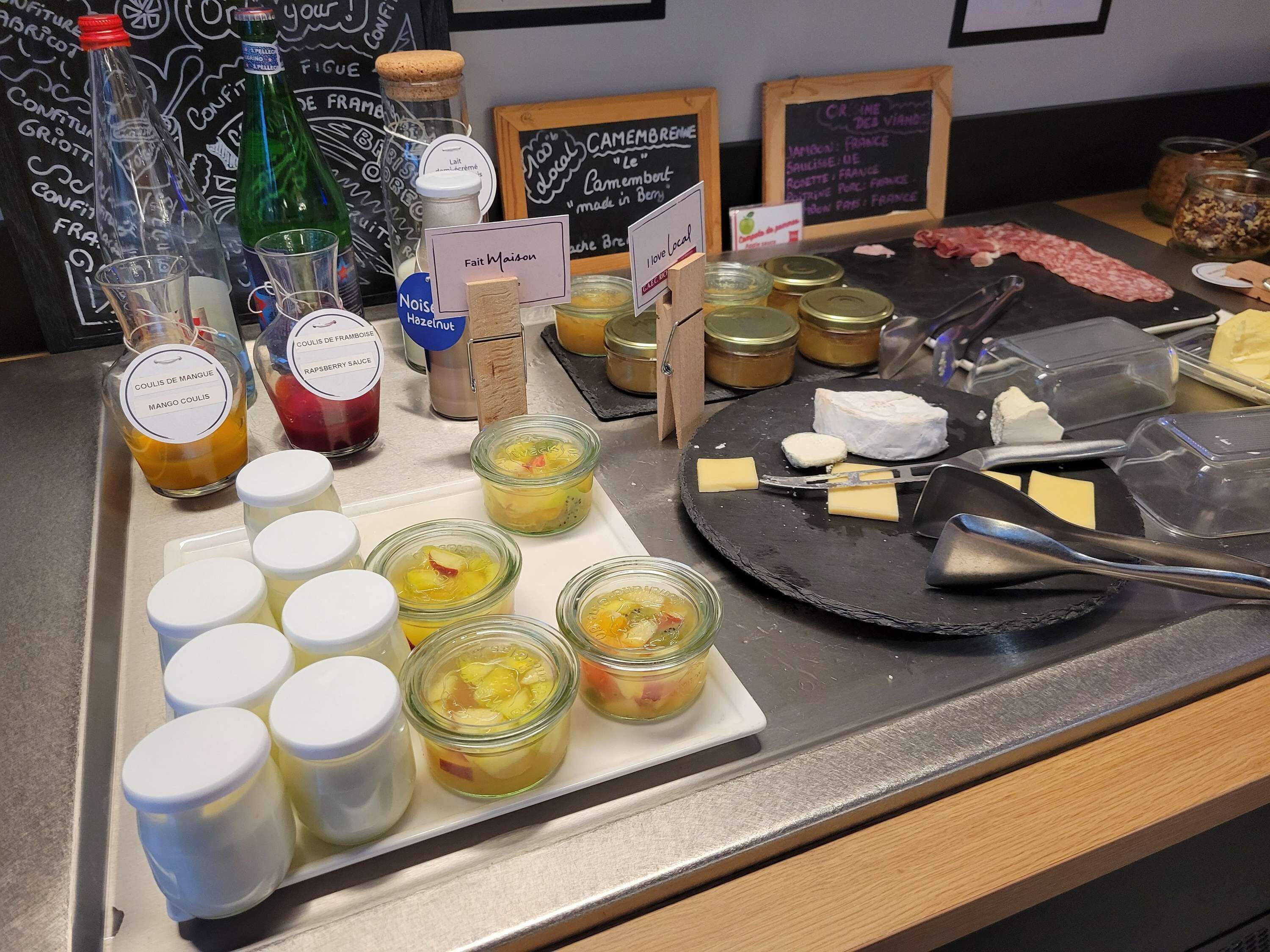 A breakfast buffet with various food items and condiments.