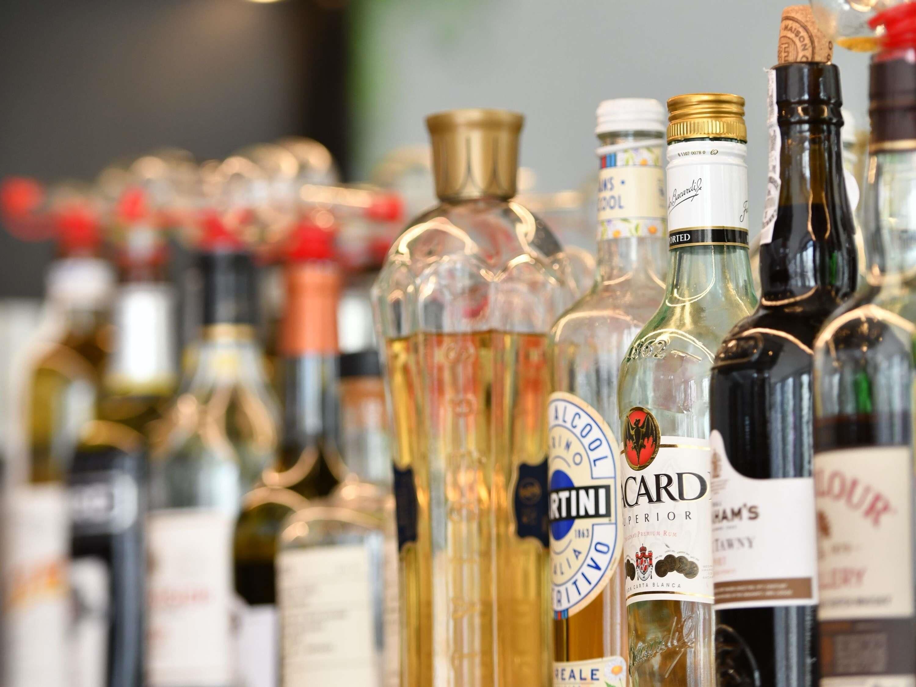 A variety of liquor bottles displayed on a shelf.