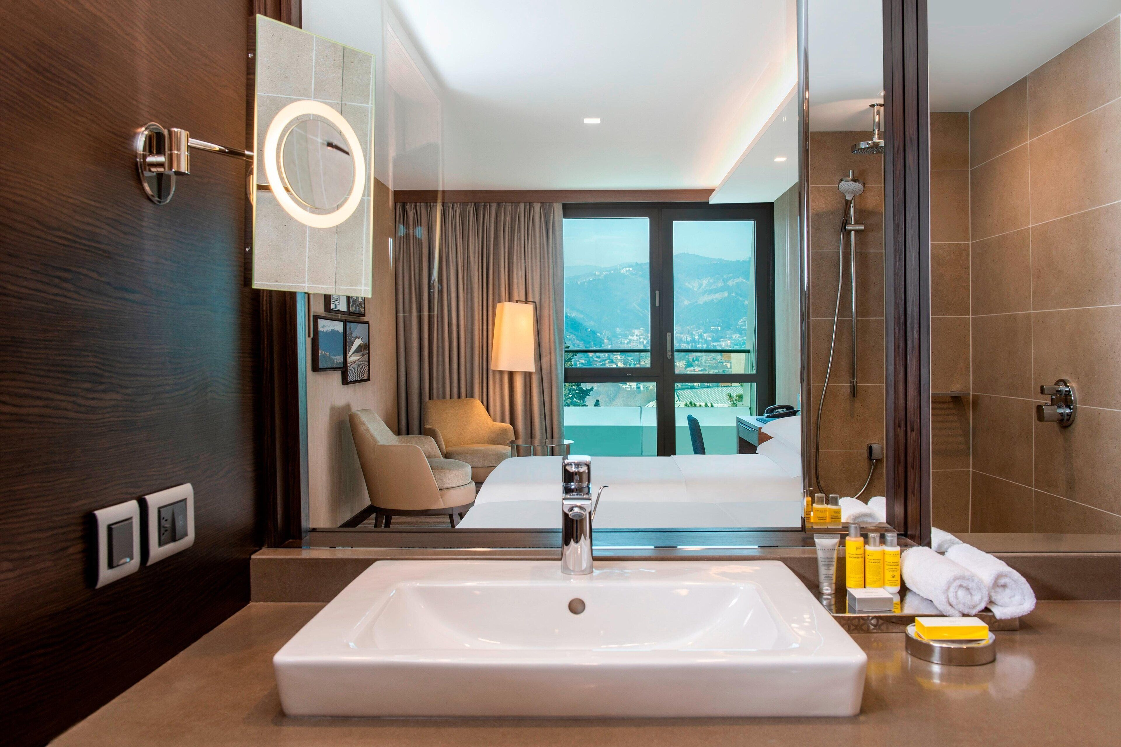 deluxe room, 1 king bed, balcony | bathroom | eco-friendly toiletries, hair dryer, bathrobes, slippers