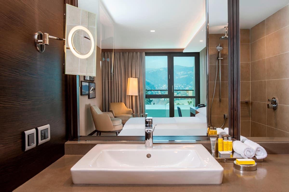 deluxe room, 1 king bed, balcony | bathroom | eco-friendly toiletries, hair dryer, bathrobes, slippers