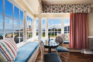 Enjoy expansive views of the coastline and distant hills from the large bay window in this inviting room.