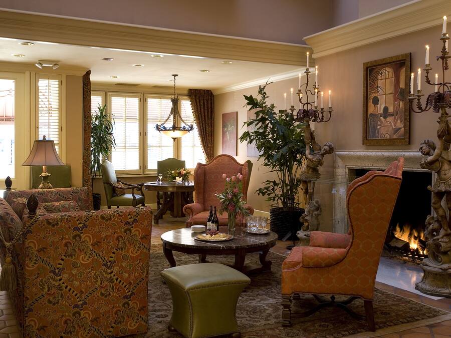 A traditional living room with a fireplace, comfortable seating, and a dining area.