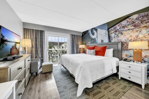A modern hotel room with a large bed, a desk with a computer, and a view of the outdoors. - Hotel Indigo Atlanta-Vinings Ballpark Area by IHG (Atlanta)