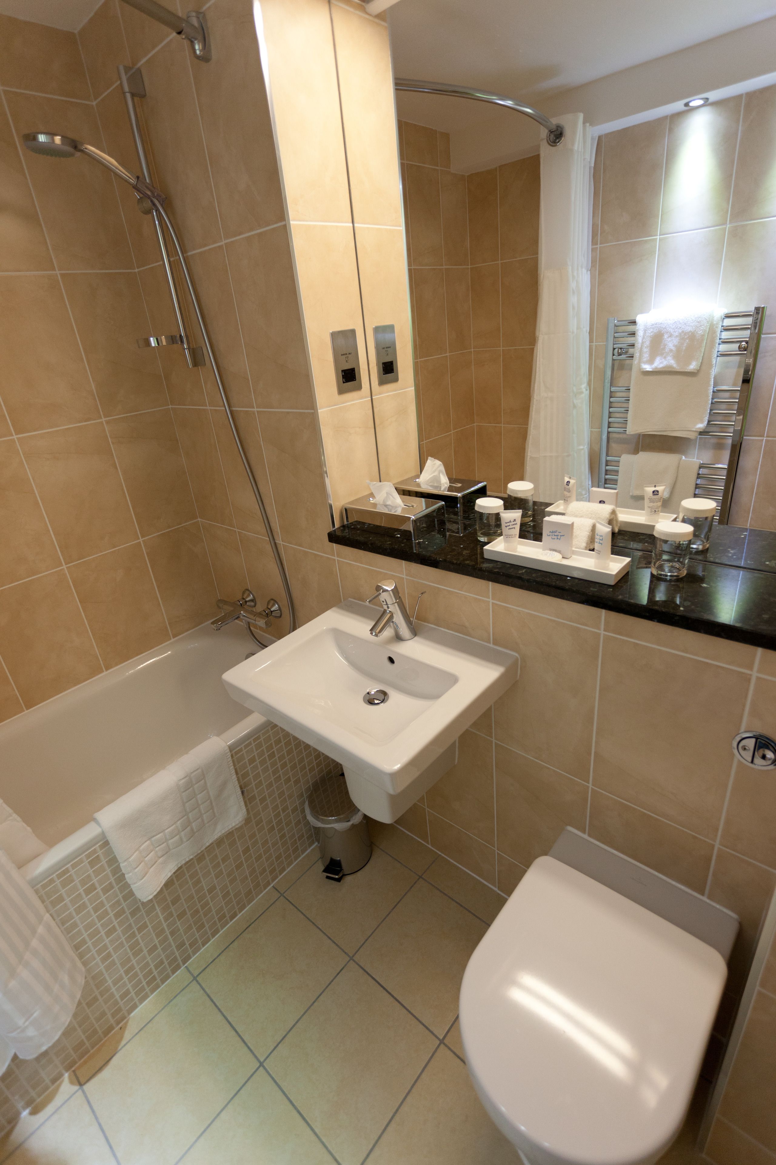 A bathroom with a bathtub, sink, and toilet.