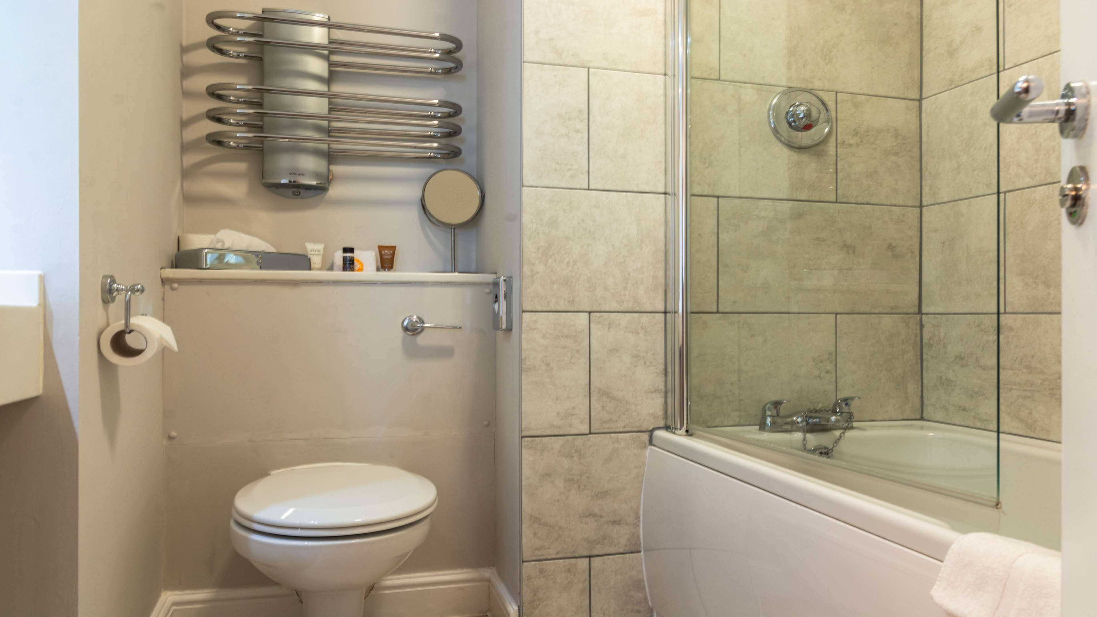 Un baño con inodoro, ducha y bañera.