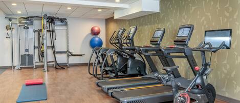 A gym with treadmills, ellipticals, and weight machines.