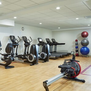 A gym with various exercise equipment including treadmills, elliptical machines, and stationary bikes. - DoubleTree by Hilton Burlington Vermont (South Burlington)