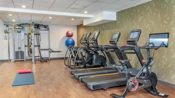A gym with treadmills, ellipticals, and weight machines.