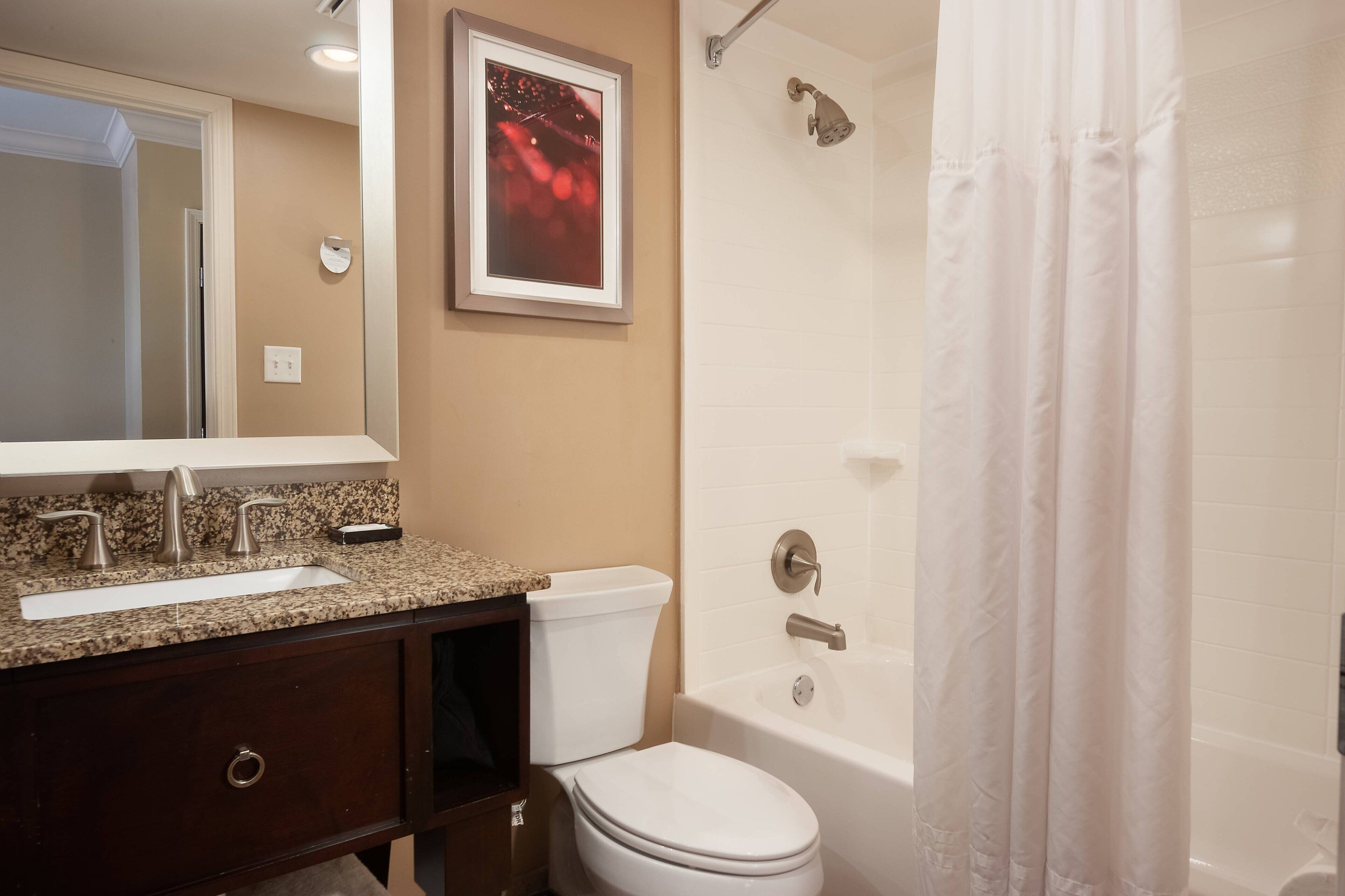 A bathroom with a sink, toilet, and bathtub.