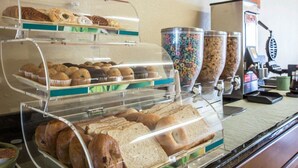 A breakfast buffet with various baked goods and cereals. - Quality Inn & Suites Monroe (Monroe)