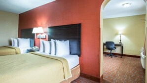 A hotel room with two beds, a desk, and a chair. - Quality Inn & Suites Monroe (Monroe)