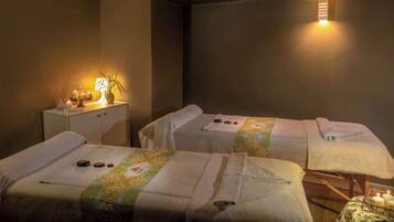 Experience tranquility in this serene spa room, featuring two massage tables and a calming ambiance.