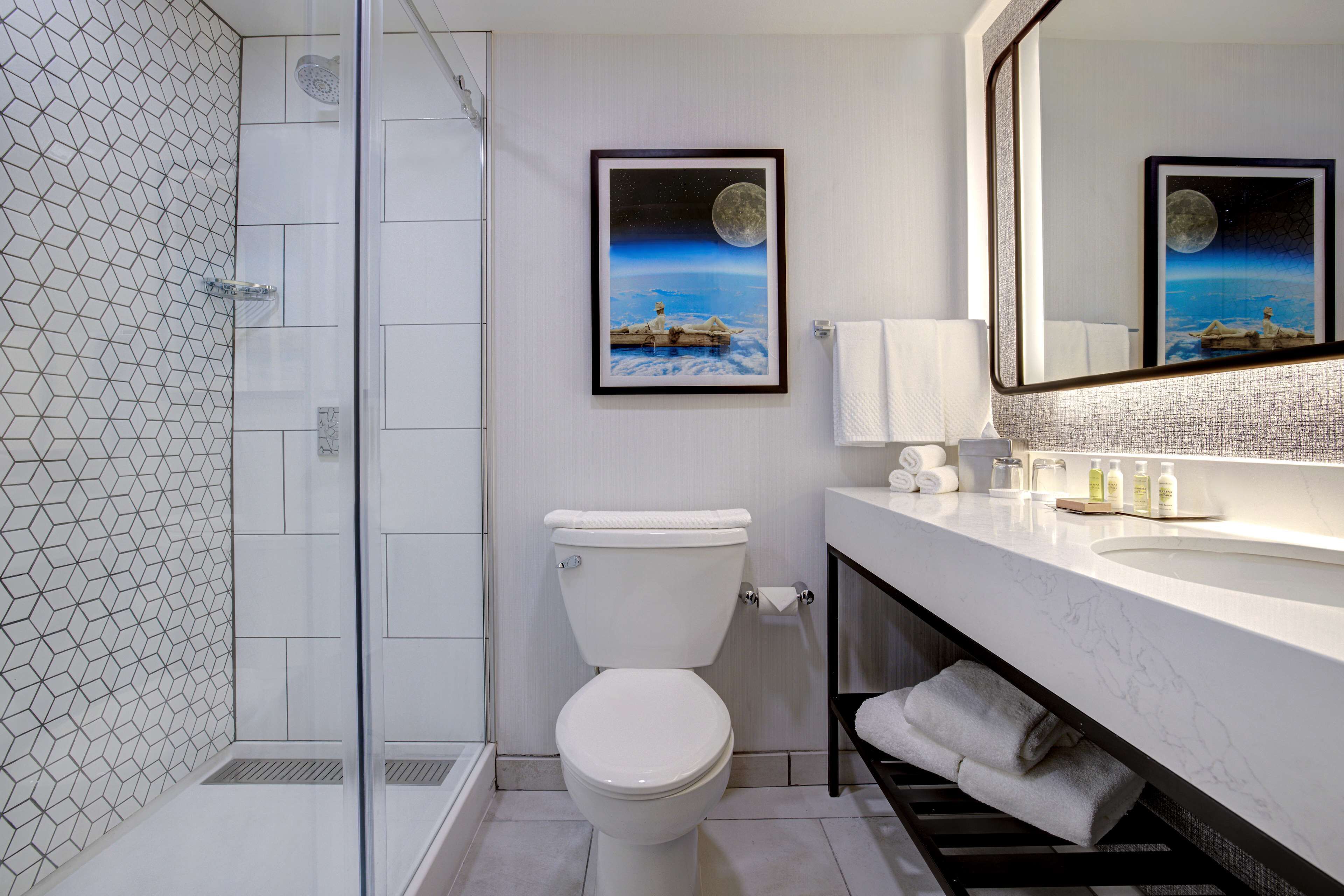 combined shower/bathtub, designer toiletries, hair dryer, towels