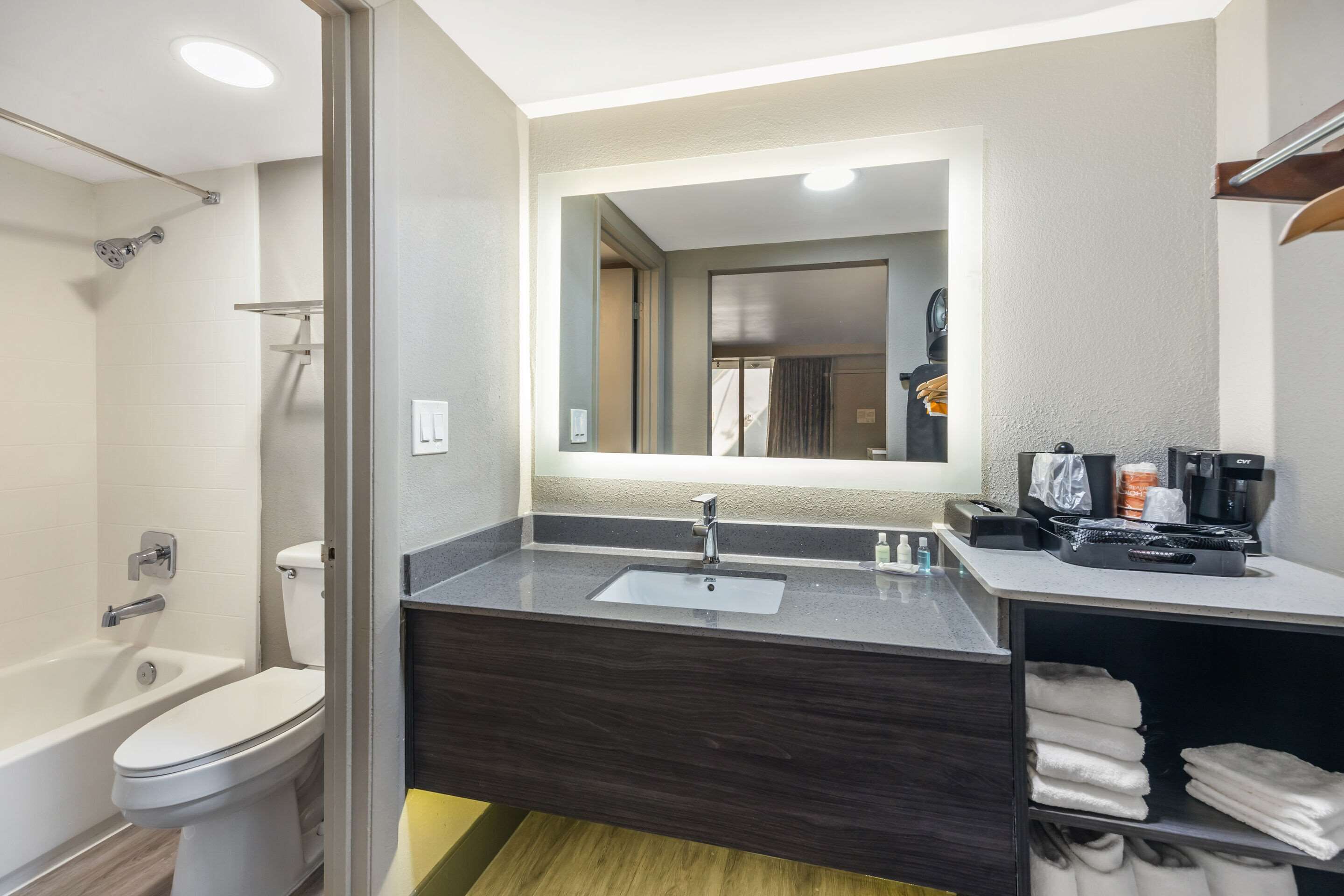 A modern bathroom with a bathtub, toilet, and sink.